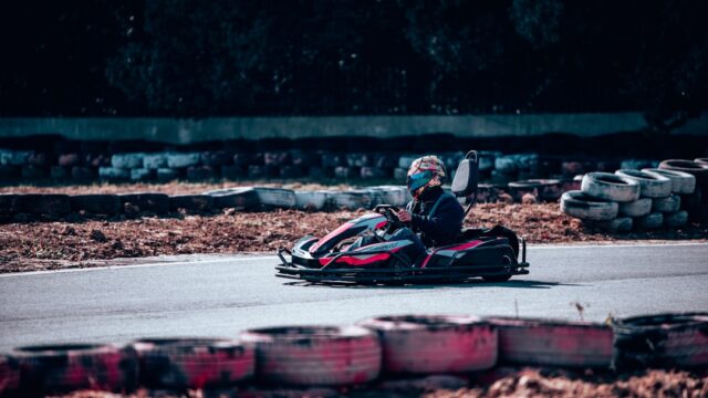 a person riding a go kart on a race track