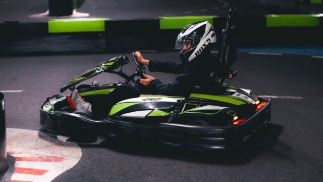 A man riding a green and black jet ski