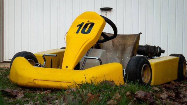 a yellow lawn mower sitting in the grass