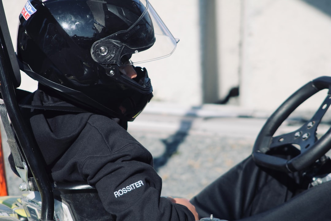 A person wearing a helmet sitting in a car