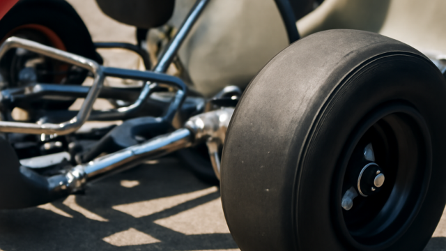 A clean, realistic editorial photograph of go kart front wheel assembly, natural light, no text or logos.