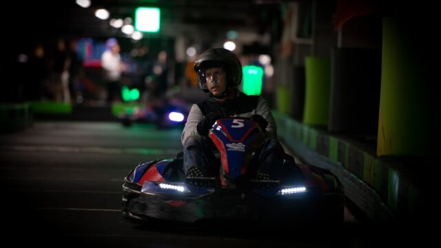 a person riding a go kart at night