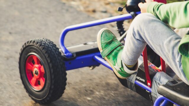 Child riding blue and black ride on toy car — Go-Kart Pedals