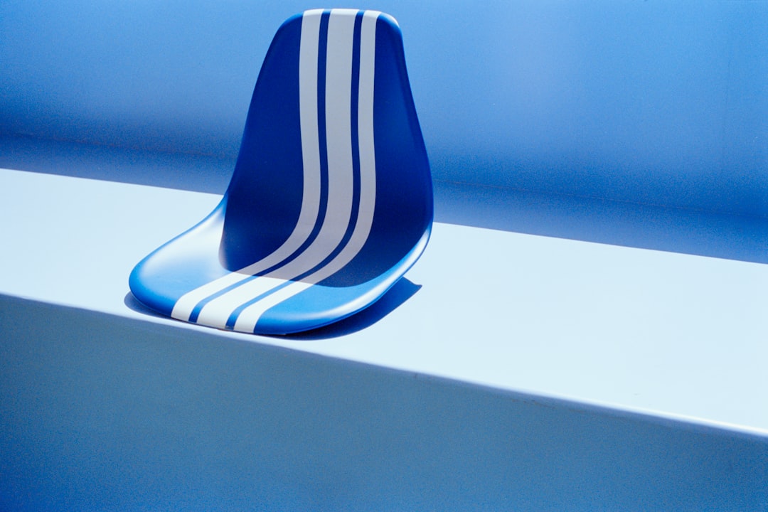 A blue seat with white stripes on a blue surface.