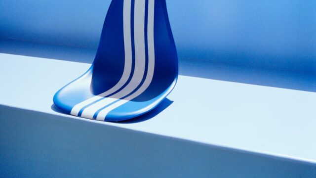 A blue seat with white stripes on a blue surface.