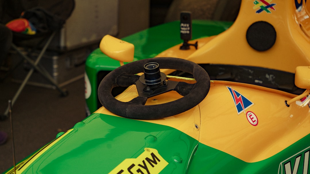 Close-up of a racing car's steering wheel and dashboard.