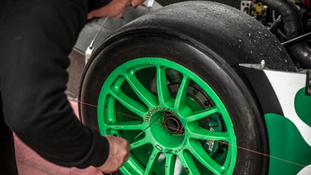 a close up of a person working on a car tire
