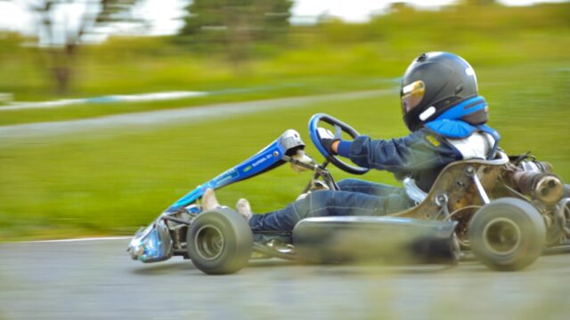 a person riding a go kart on a road