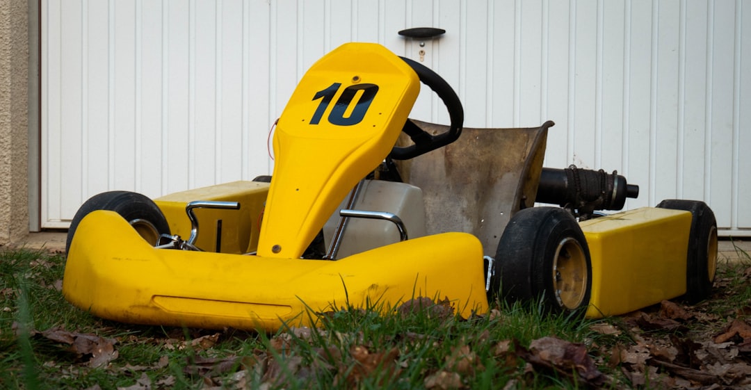 a yellow lawn mower sitting in the grass