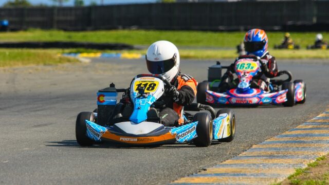 two go kart drivers on race track