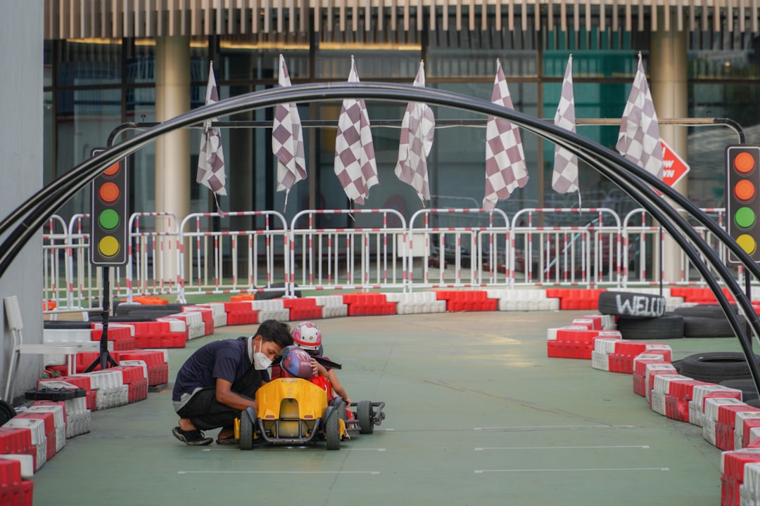 A man working on a vehicle in front of a traffic light