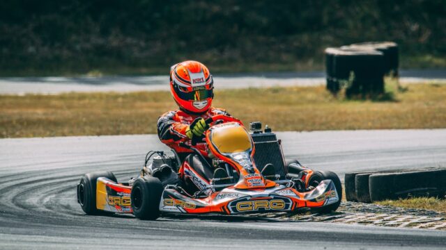 a person riding a go kart on a race track