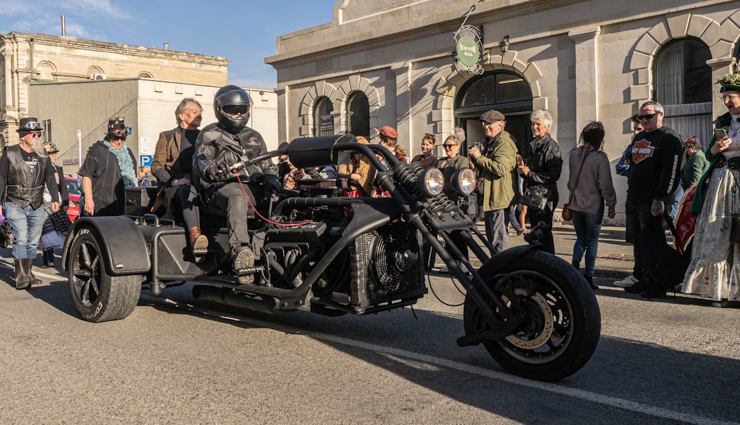 A group of men riding motorcycles down a street — Motorized Drift Trikes