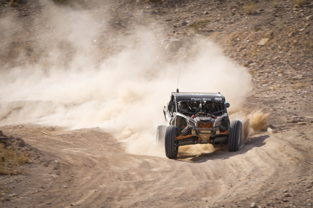 A person driving a buggy on a dirt road — Off-Road Go-Karts Under $500