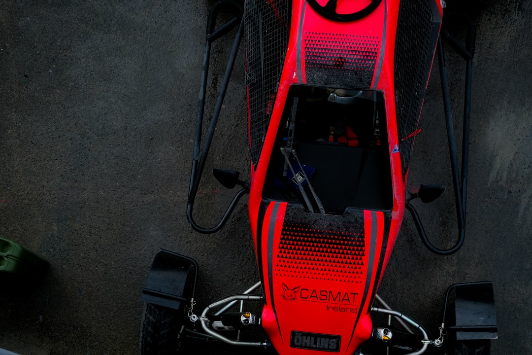 Red go-kart with black accents on dark surface