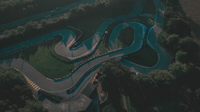 an aerial view of a curved road in a park