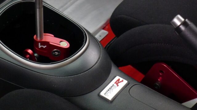 a close up of a steering wheel with a sticker on it