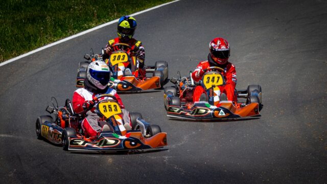 people riding on red and black go kart