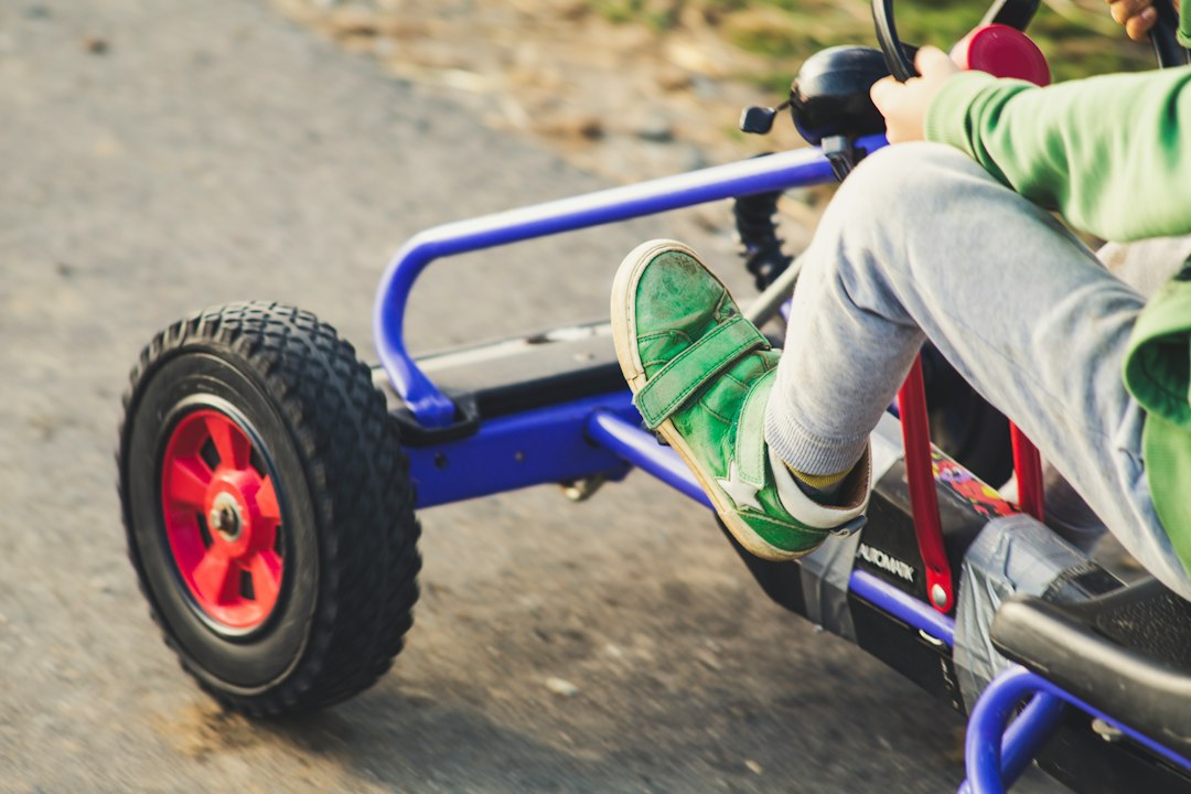 Child riding blue and black ride on toy car — Children’s Pedal Go-Kart