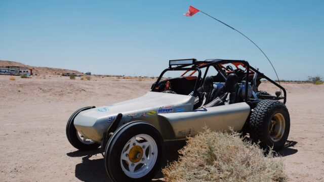 A dune buggy is parked in the desert