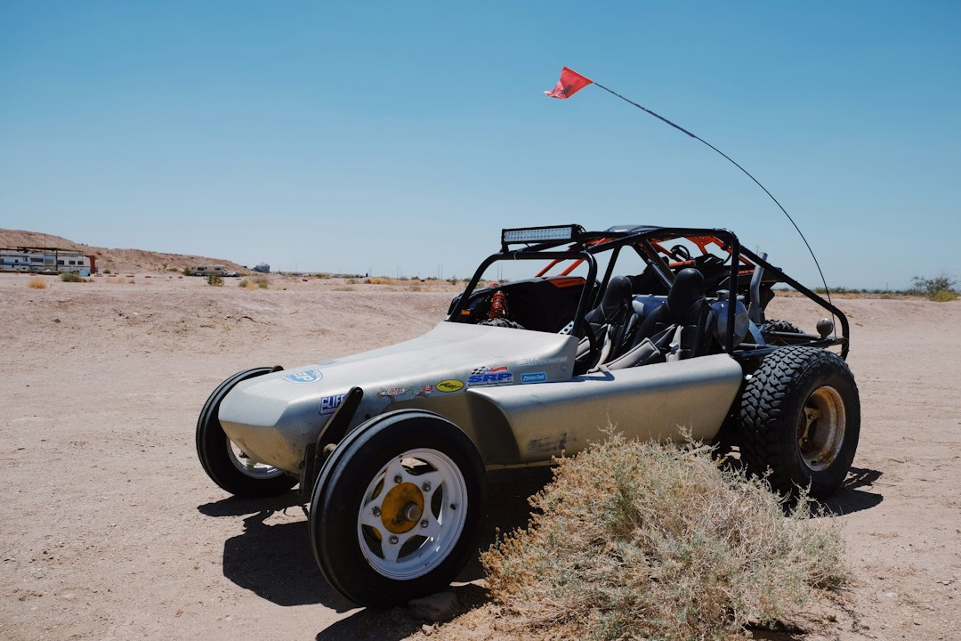 A dune buggy is parked in the desert