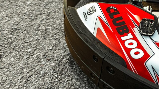 A go-kart with "club 100" branding on asphalt — Go-Kart Brake Pads