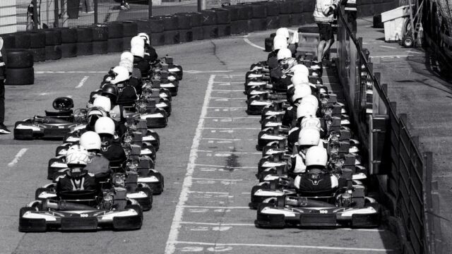 Two rows of go-karts lined up on a race track — Go-Kart Racing License