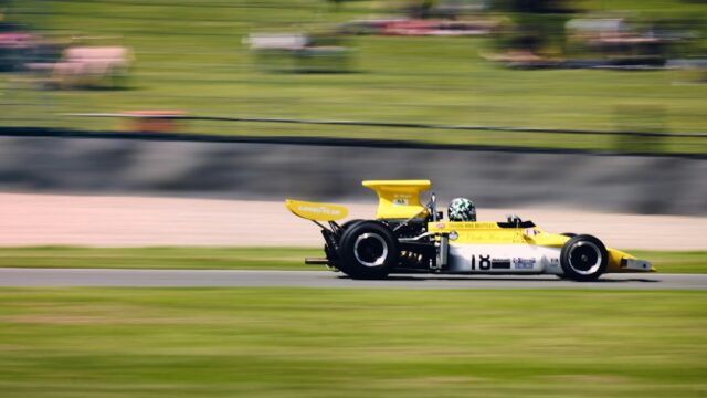 A yellow race car driving down a race track — Indy Kart Racing
