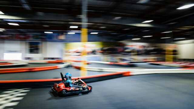 A person riding a go-kart in a race track — Kart Braking Technique
