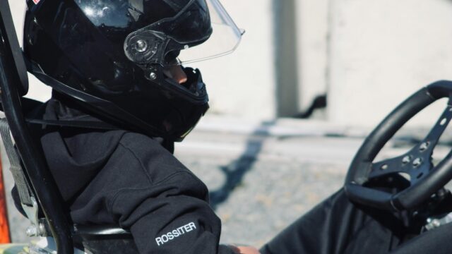 A person wearing a helmet sitting in a car — Kart Racing Rib Protector Guide