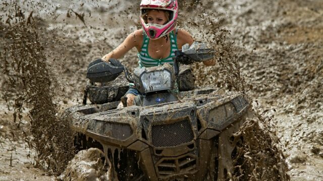 Woman riding on off-road ATV