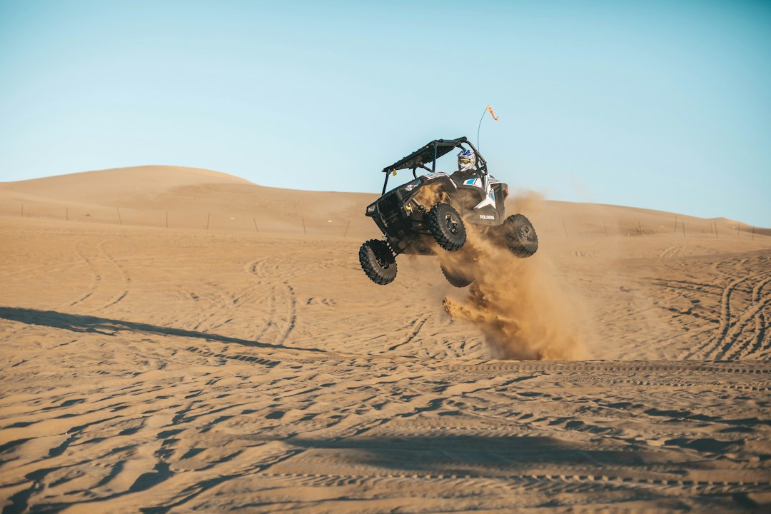Man riding on UTV on desert during daytime — TrailMaster Go Kart Models