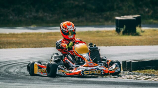 A person riding a go-kart on a race track — Vintage Go-Kart Motor